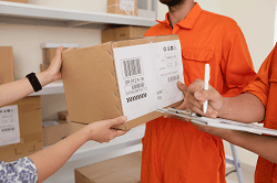 close-up-hands-handing-delivery-boxes-courier (1)